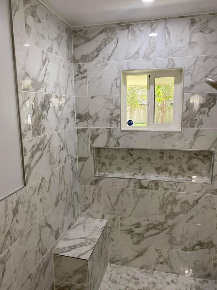 Marble walk-in shower with bench