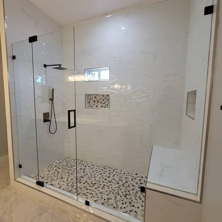 Frameless glass shower enclosure